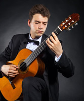 Man playing guitar with Butterfly Finger Picks